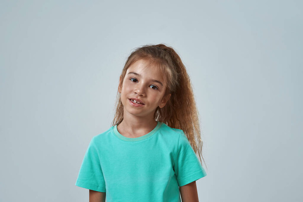 Cropped of serious little girl looking at camera - Foto, imagen