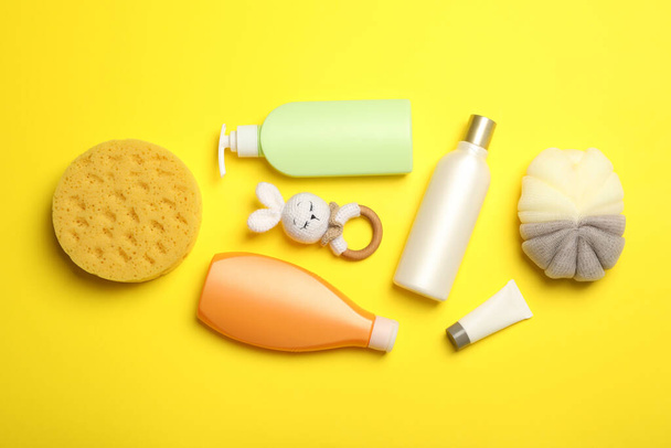 Flat lay composition with baby cosmetic products on yellow background - Fotoğraf, Görsel