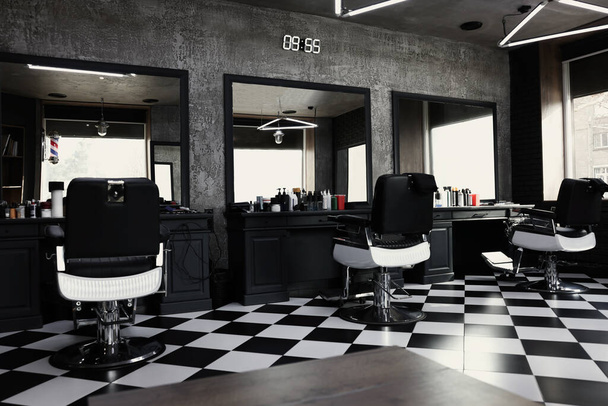 Stylish monochrome interior of modern barbershop. Equipped workplace - Photo, Image