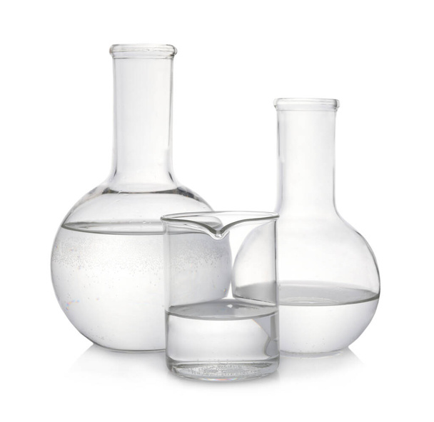Laboratory glassware with transparent liquid on white background - Fotografie, Obrázek