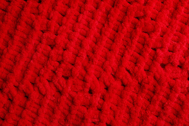 Soft red knitted fabric as background, top view - Foto, immagini