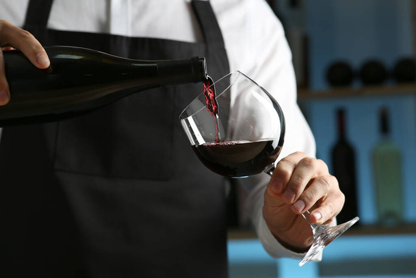 Bartender pouring wine into glass in restaurant, closeup - Foto, Imagen