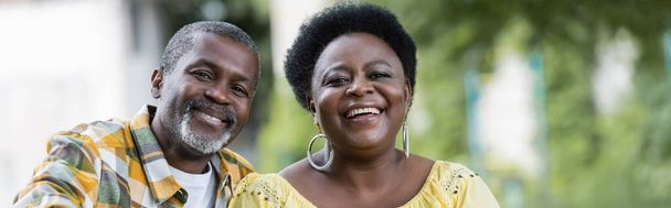 smiling and senior african american couple looking at camera, banner - Fotó, kép