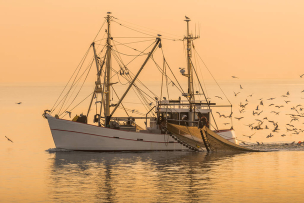 Fishing boat on the North Sea fishes with a trawl net, Buesum, Schleswig-Holstein, Germany - Photo, Image