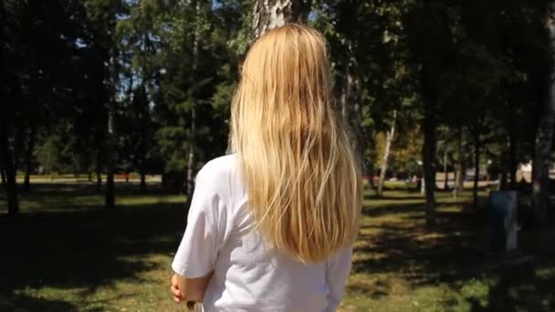 Blonde girl rear view. Natural background. - Footage, Video