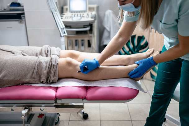 Young woman receiving laser epilation or permanent body hair removal treatment. Modern technology and beauty concept. - Фото, зображення