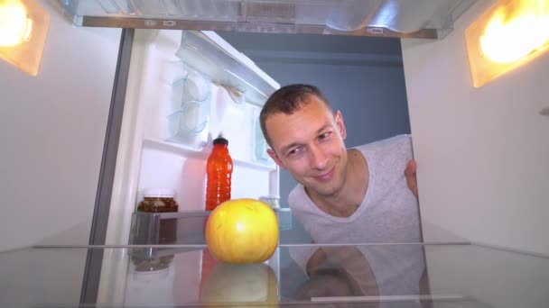 el muchacho abre el refrigerador, en que hay solamente una manzana. - Imágenes, Vídeo