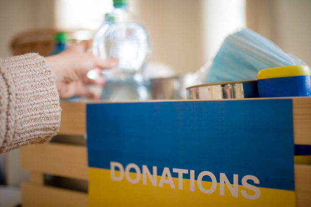 Close up of box of aid for Ukrainian refugees. Humanitarian aid concept. - Fotografie, Obrázek