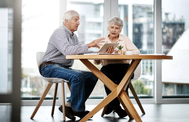 Taking a look at their investments and annuities. Full length shot of a senior couple working on their finances at home. - Foto, Bild