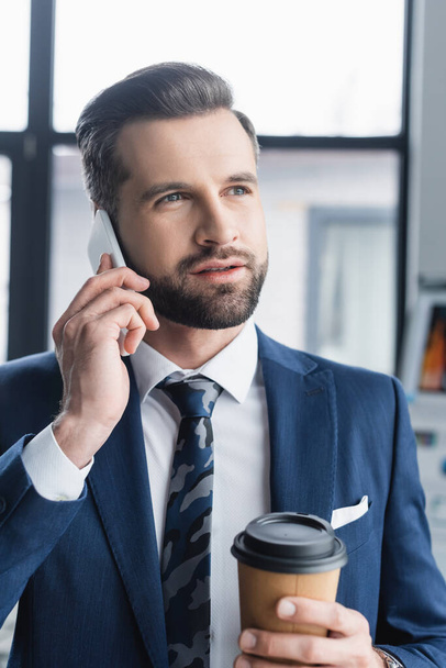 bearded businessman with coffee to go talking on mobile phone in office - Fotografie, Obrázek