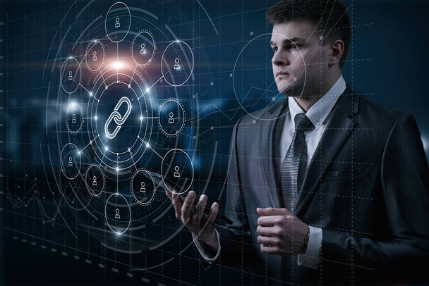 Man in suit studying web link icon connecting users on virtual screen. - Photo, Image