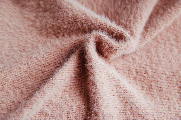 Pink fluffy fabric for drapery. A piece of warm cloth with folds. Wrinkled and shaggy Texture - 写真・画像