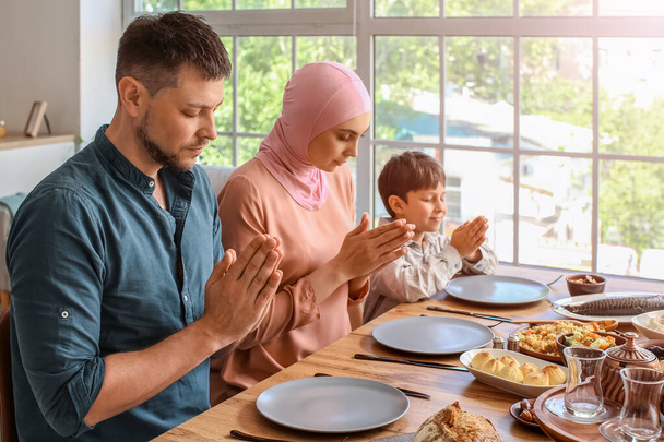 Muslim family praying together before breakfast. Celebration of Eid al-Fitr - Photo, image