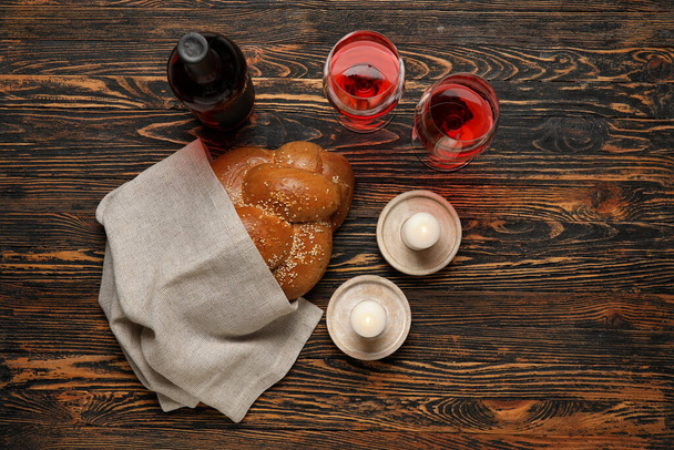 Tradycyjny chleb chała z winem i świecami na drewnianym tle. Szabat Szalom - Zdjęcie, obraz