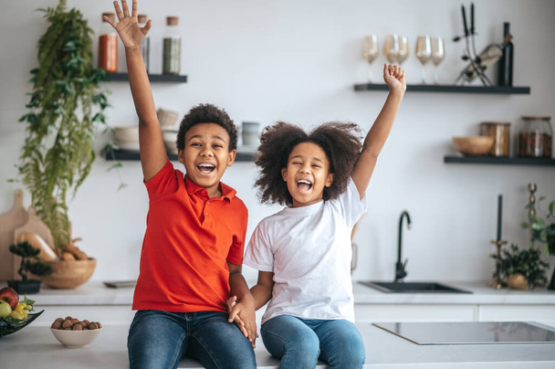 Two sibling having good time at home and feeling joyful - Photo, image
