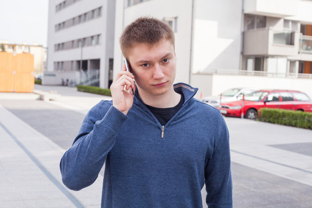 Man in urban background talking on phone. - Fotó, kép