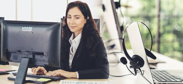 Business people wearing headset working in office broaden view - Photo, Image