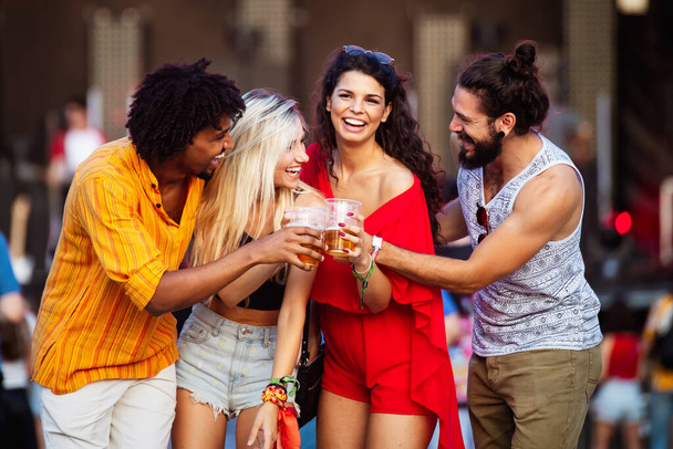 Group of young happy people enjoying outdoor music festival - Photo, image