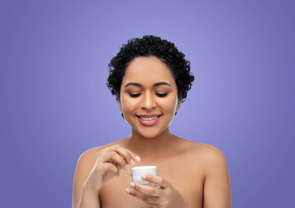 young african american woman with moisturizer - Фото, зображення