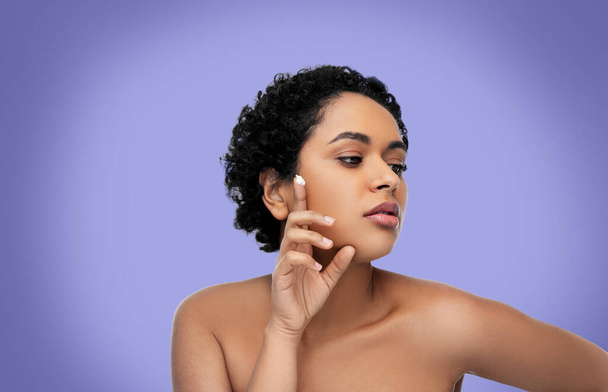 young african american woman with moisturizer - Foto, Imagen