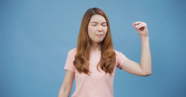 Youth Asia lady wear casual pink irritated annoyed bad mood fight with boyfriend show bla bla blah gesture stand isolate over blue background, People emotions lifestyle, Copy space concept. - Footage, Video