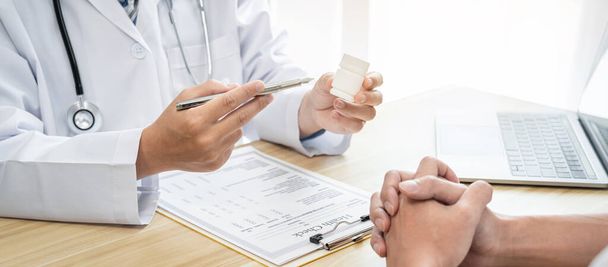Doctor discussing with the patient using the medicine something and recommend treatment methods, Presenting results on report, Medicine and Healthcare concept. - Photo, image
