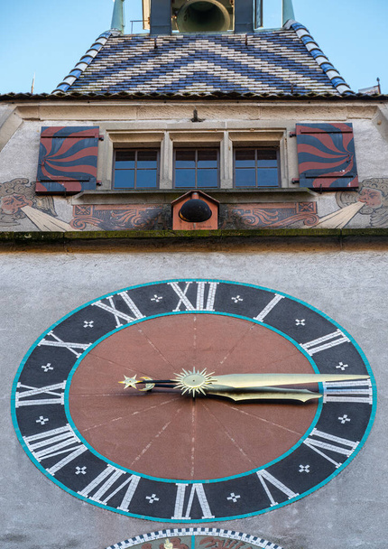 Zug, Switzerland - December 31, 2021: A tower in canton Zug with medieval clock and windows above - Photo, Image