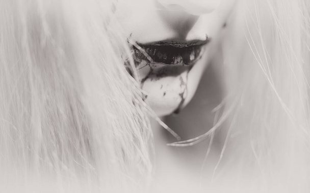 Woman with bloody mouth close up photo - 写真・画像