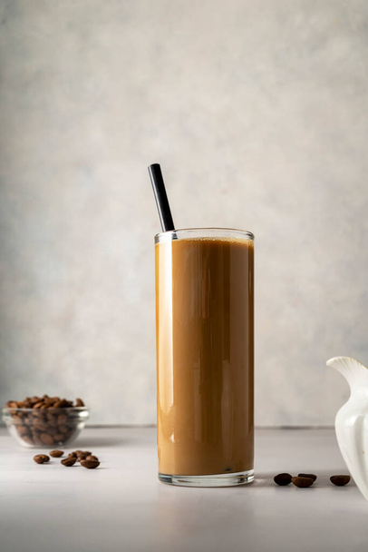 Iced coffee with milk. Cold refreshment summer drink, bright background - Foto, imagen