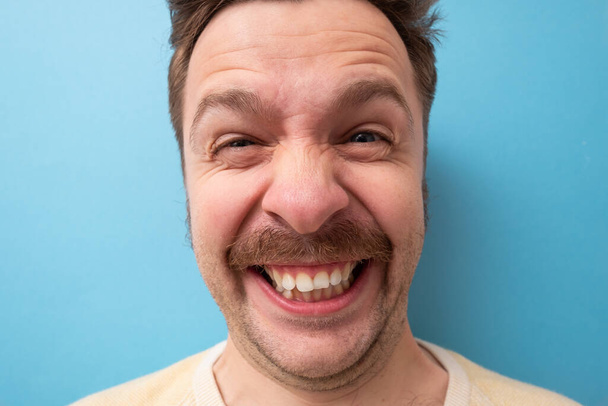 Portrait of a funny caucasian man with mustache laughing - Photo, Image