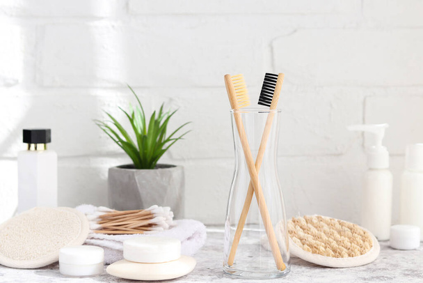 Different eco-friendly bathroom accessories. Bamboo toothbrushes, ear sticks, facial sponges, soaps and various moisturizers. Zero waste concept - Photo, Image