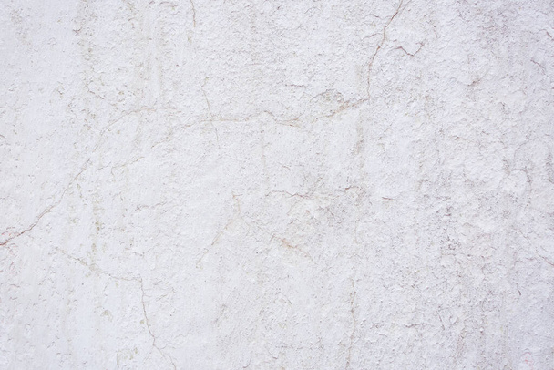 texture of a concrete wall with cracks and scratches which can be used as a background - Photo, Image