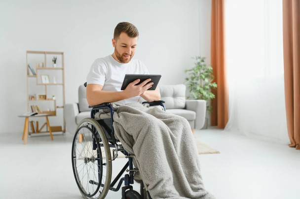 Młody przystojny człowiek na wózku inwalidzkim - Zdjęcie, obraz
