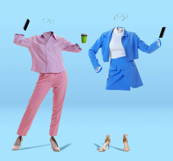 Two stylish invisible women wearing modern casual style outfits and eyeglasses using phones on blue background. Concept of fashion, style - Valokuva, kuva