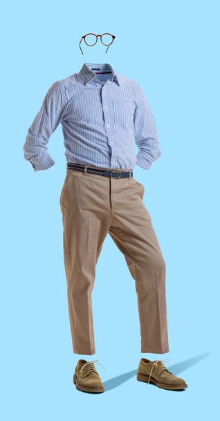 Creative portrait of invisible man wearing modern business style outfit and eyeglasses against blue background. Concept of fashion, creativity - Fotó, kép