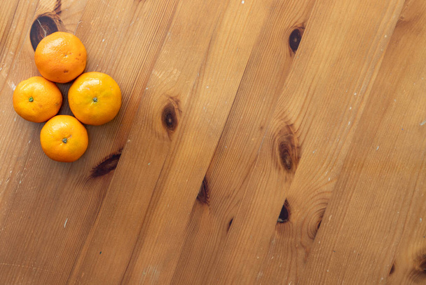 Een platte lay style afbeelding van sinaasappels op een houten achtergrond - Foto, afbeelding