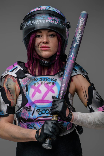 Portrait of aggressive female protester with baseball bat - Photo, Image