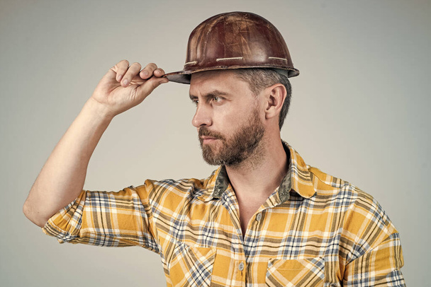 man architect with serious look. guy wear worker uniform. handsome builder in helmet. - Fotografie, Obrázek