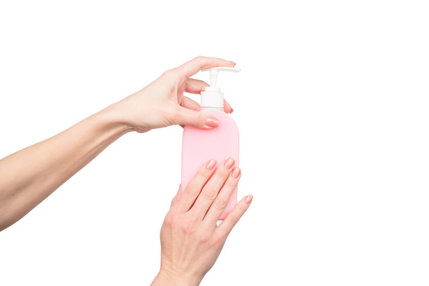 female hands hold soap dispenser with copy space - Valokuva, kuva