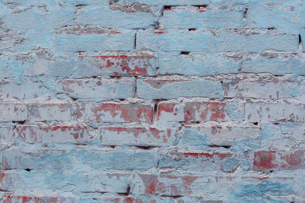 texture of a brick wall with cracks and scratches which can be used as a background - Foto, afbeelding