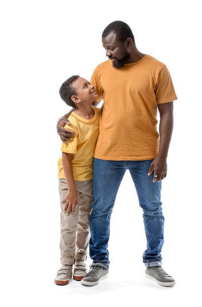 Portrait of African-American man with his little son on white background - Φωτογραφία, εικόνα