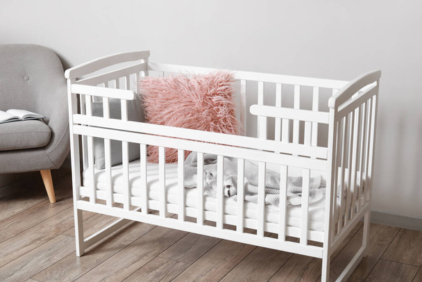 Comfortable crib near light wall in children's room - Photo, Image