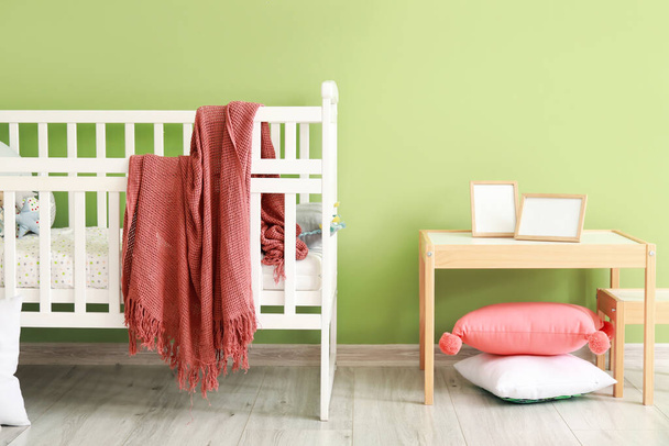 Baby crib with decor in modern children's room - Fotó, kép