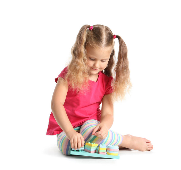 Adorable little girl playing with building blocks on white background - Photo, Image