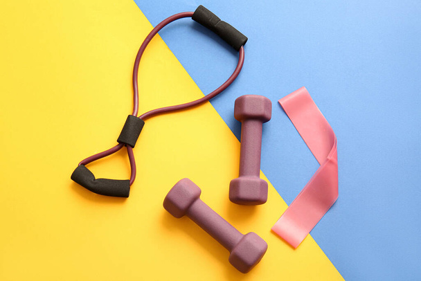 Stylish elastic band, fitness expander and elastic band on color background - Photo, Image
