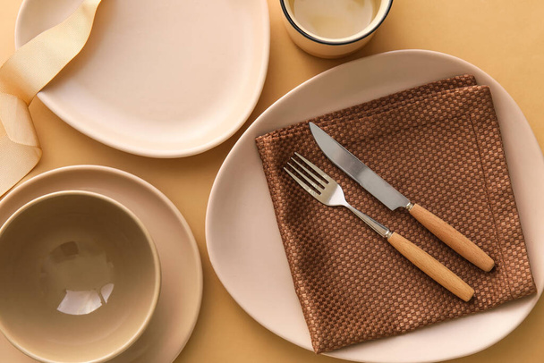 Set of stylish dinnerware on beige background - Zdjęcie, obraz