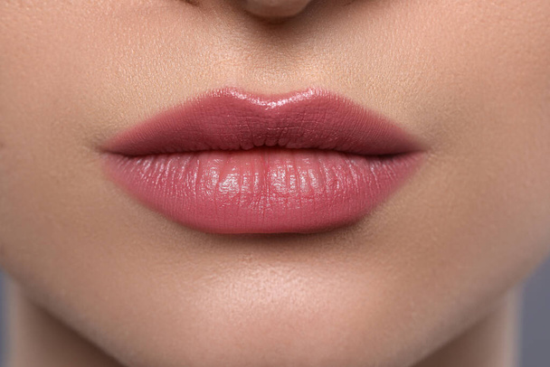 Young woman with beautiful plump lips, closeup - Photo, image
