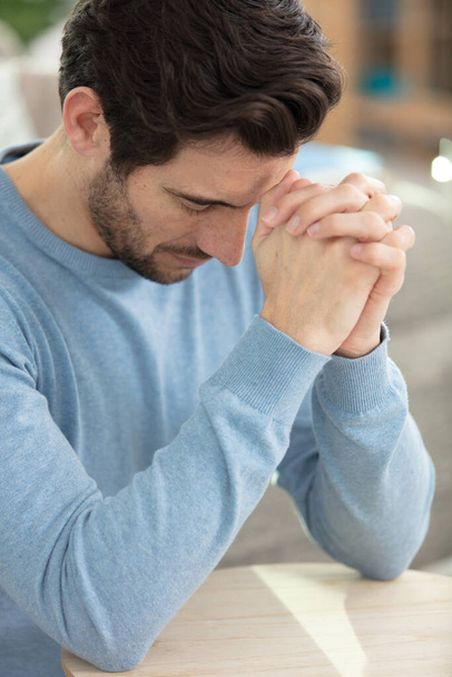 religious young man praying to god at home - 写真・画像