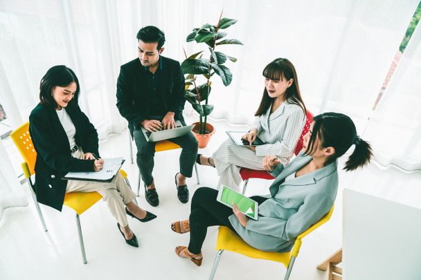 Business people proficiently discuss work project while sitting in circle - Photo, Image