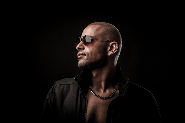 Dark photos of a mysteryous handsome young man with sunglasses - Фото, зображення